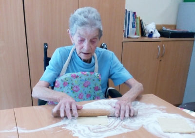 A female Abbotsleigh resident carefully rolling out pastry for a batch of homemade jam tarts