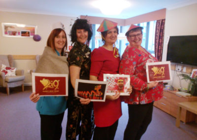 Staff dressed up in Chinese costume with Chinese pictures