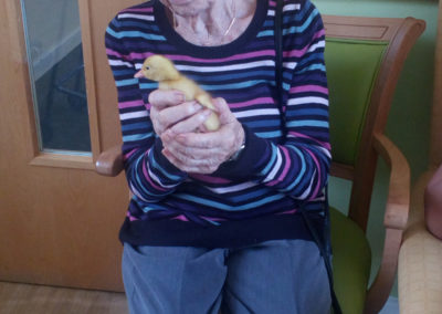 Female resident holding a duckling