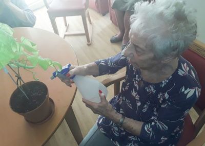 Resident watering plants at Hengist Field Care Home
