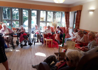 Residents at Hengist Field Care Home knitting poppies for St Peter and St Paul Church in Borden