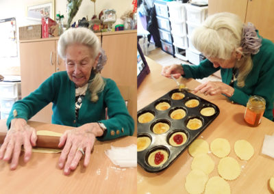 Lady resident at Hengist Field Care Home rolling out pastry and filling tarts with jam