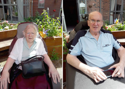 Two residents at Hengist Field Care Home sitting in the shade in the garden