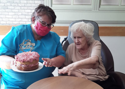 Hengist Field resident receiving her birthday cake