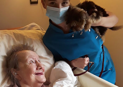 Baby the Yorkshire Terrier making a resident smile at Hengist Field Care Home