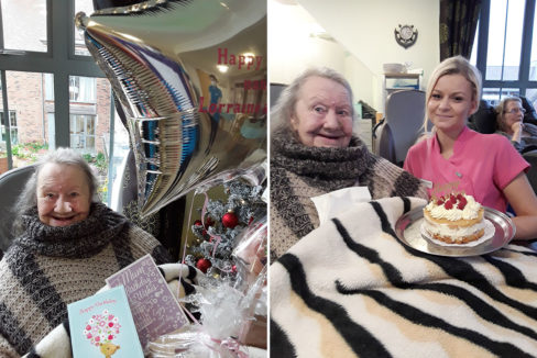 Resident on her birthday with her gifts and cake at Hengist Field Care Home