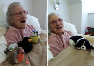 Resident enjoying cuddly toy birds at Hengist Field Care Home