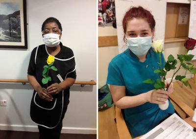 Two Hengist Field Care Home staff with yellow roses