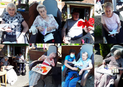 Hengist Field Care Home residents outside painting butterflies