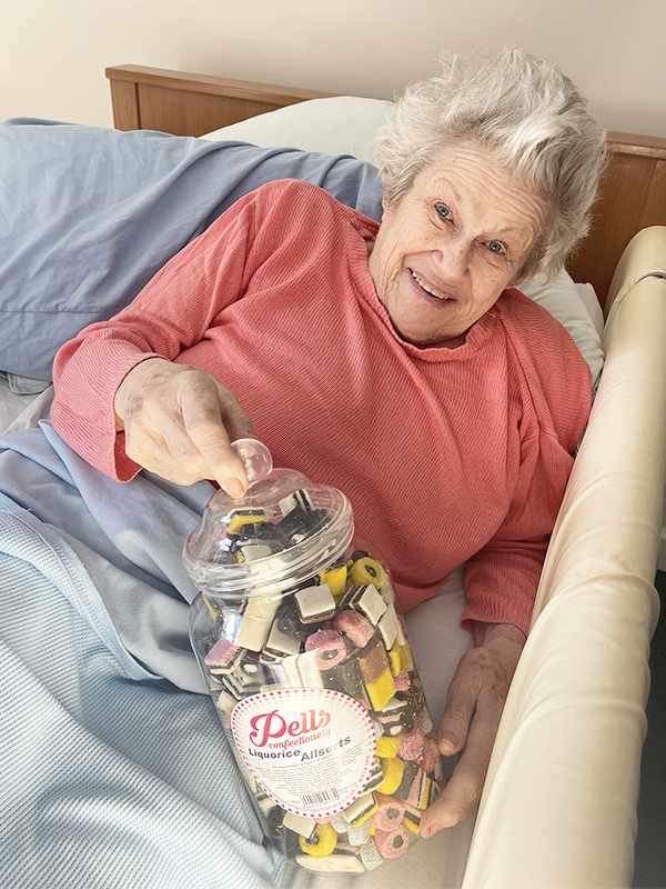 Hengist Field Care Home resident with a big jar of liquorice all sorts