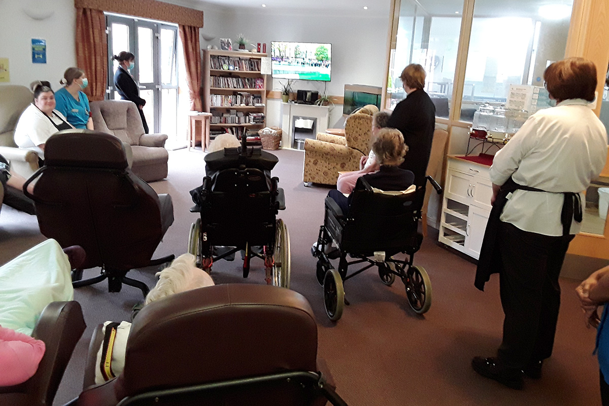 Residents and staff watching the Remembrance parade on television at Hengist Field Care Home