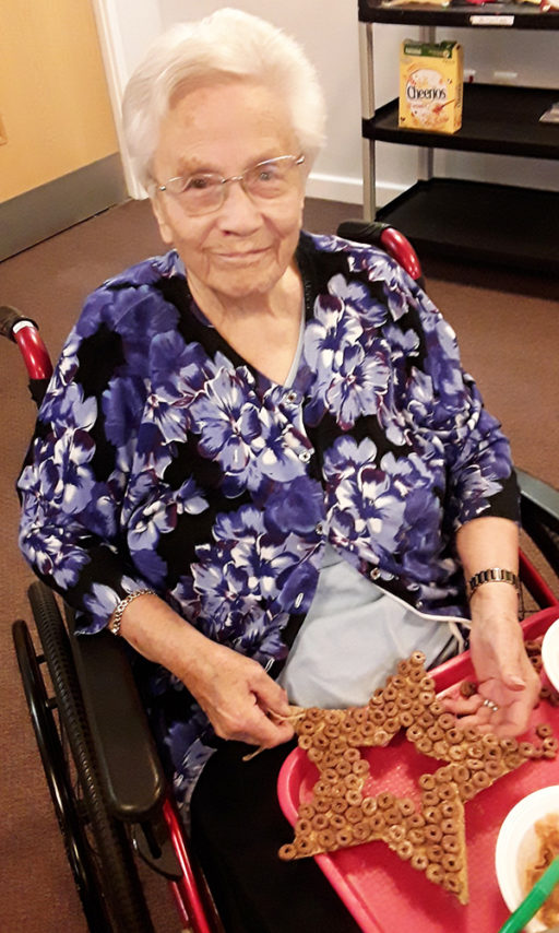 Resident with her star shaped bird feeder at Hengist Field Care Home