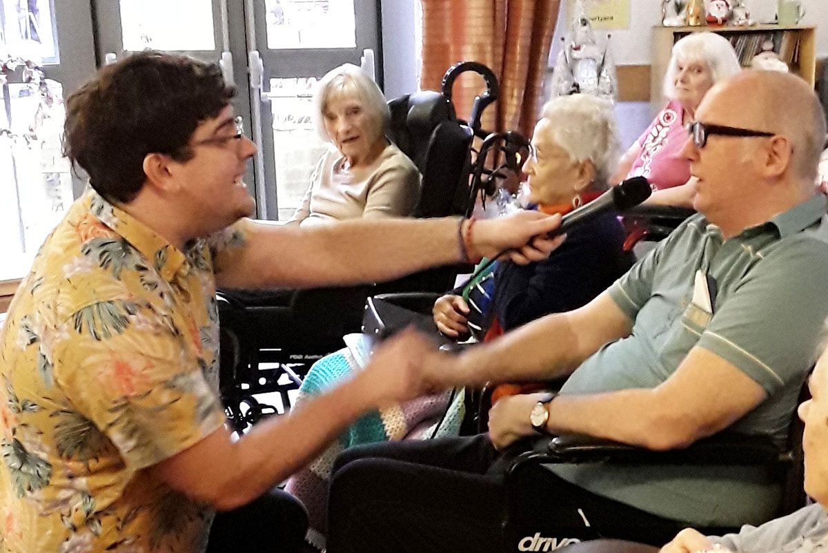 Fred Clark singing with a Hengist Field Care Home resident