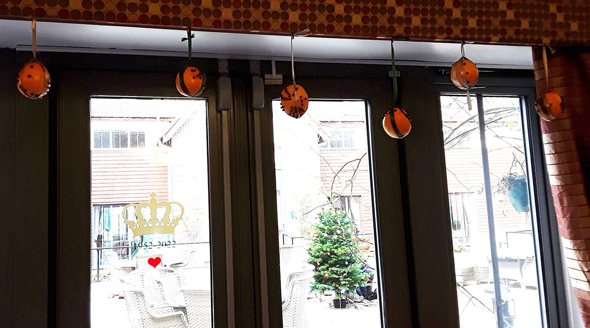 Hanging Christmas pomanders at Hengist Field Care Home